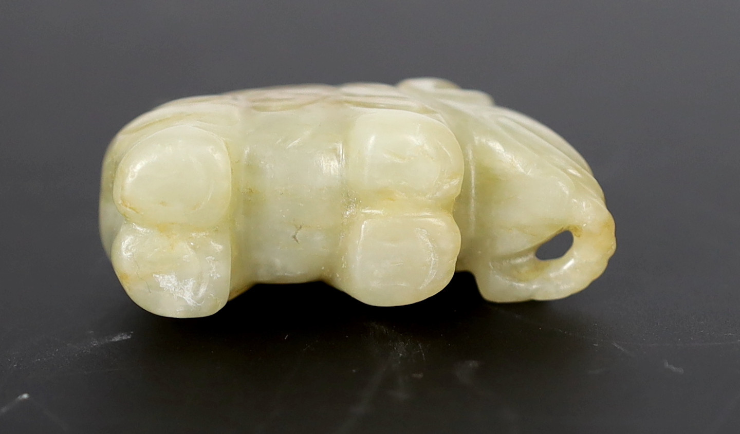 A Chinese small mellow green jade model of a standing elephant, 17th century